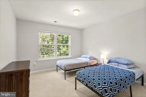 a living room with furniture a flat screen tv and a floor to ceiling window