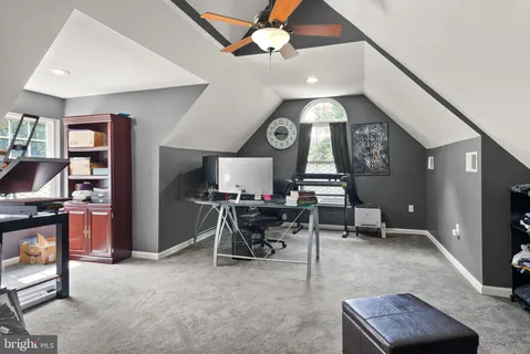 a view of a house with a yard and potted plants