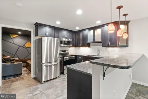 a view of a roof deck with couches and wooden floor