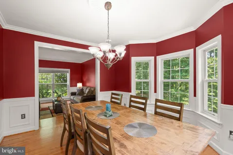 a kitchen with stainless steel appliances granite countertop a sink dishwasher stove refrigerator and cabinets with wooden floor