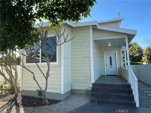 a view of a pathway with a flower garden