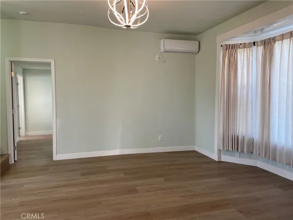 an empty room with wooden floor