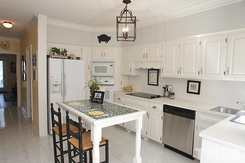 2007 Landings Way Raleigh, NC 27615 - Photo 6 of 17 a kitchen with stainless steel appliances a stove a sink island and white cabinets