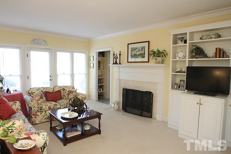 2007 Landings Way Raleigh, NC 27615 - Photo 8 of 17 a living room with furniture a flat screen tv and a fireplace