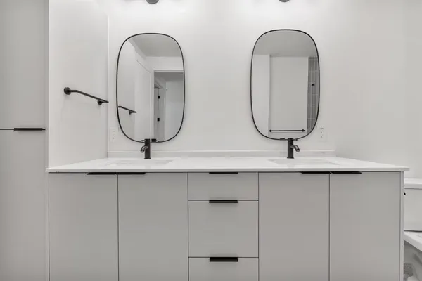 a view of two mirror and a wooden wall