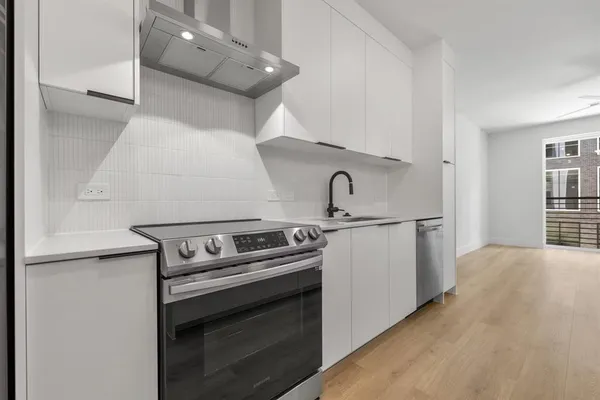 a kitchen with a stove and a microwave