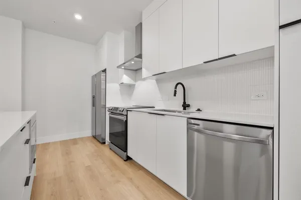 a kitchen with a sink and a refrigerator