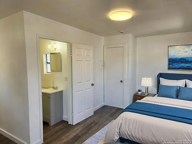 a bedroom with a bed and a lamp