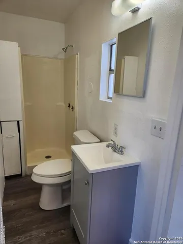 a bathroom with a sink toilet and mirror