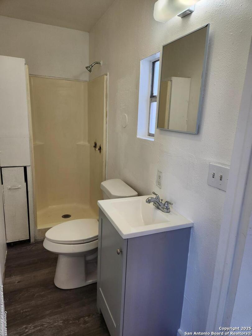 519 Topeka Boulevard, Unit 3 San Antonio, TX 78210 - Photo 7 of 7 a bathroom with a sink toilet and mirror