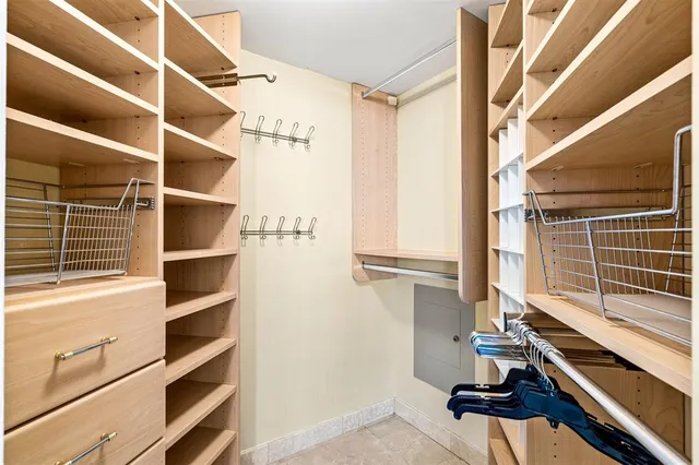 a view of a walk in closet and a living room