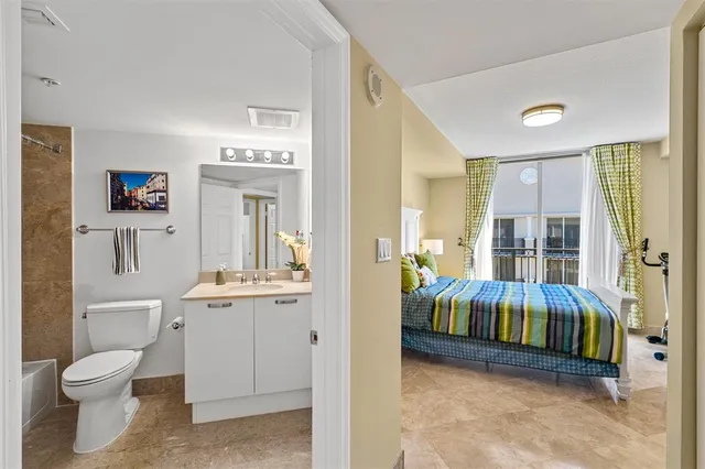 a bathroom with a sink mirror toilet and bathtub
