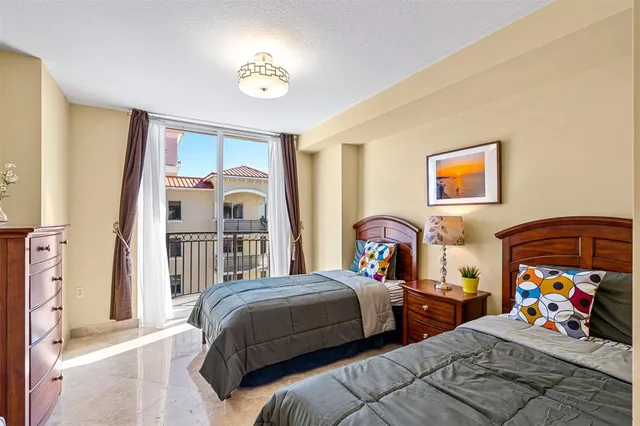 a bedroom with two beds and a baby crib