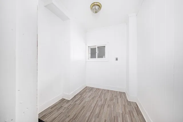 a view of a room with wooden floor