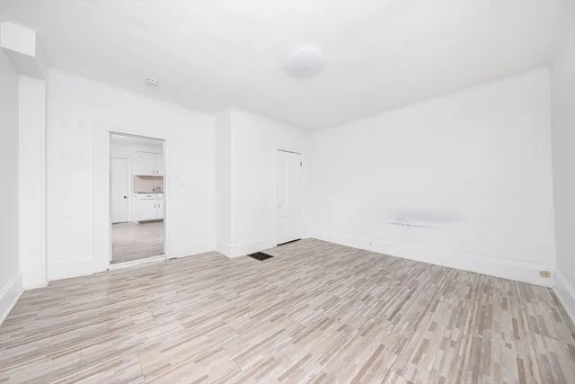 a view of an empty room and wooden floor