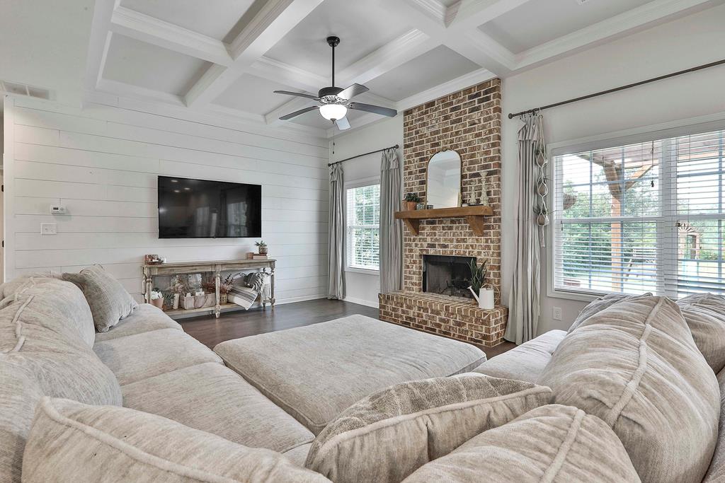 169 Hart Ridge Court Fortson, GA 31808 - Photo 17 of 50 a living room with couches a fireplace and a flat screen tv