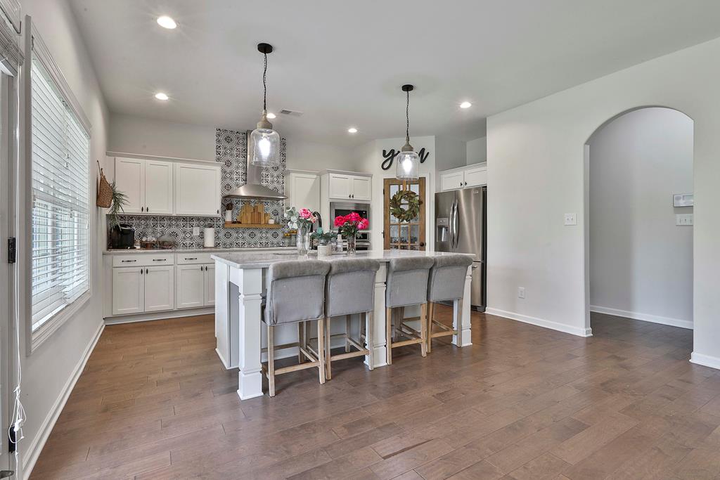 169 Hart Ridge Court Fortson, GA 31808 - Photo 20 of 50 a kitchen with kitchen island granite countertop a dining table chairs and white cabinets