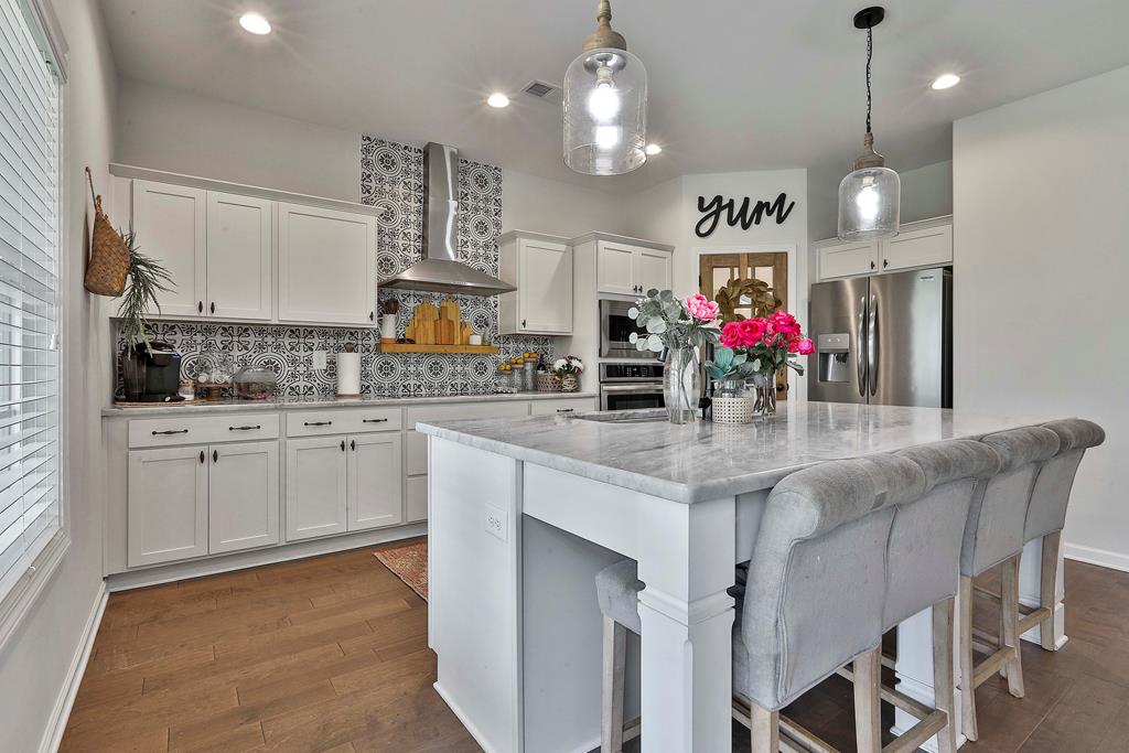 169 Hart Ridge Court Fortson, GA 31808 - Photo 21 of 50 a kitchen with kitchen island granite countertop a sink cabinets and stainless steel appliances