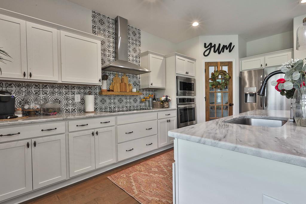169 Hart Ridge Court Fortson, GA 31808 - Photo 22 of 50 a kitchen with cabinets appliances and a counter top space