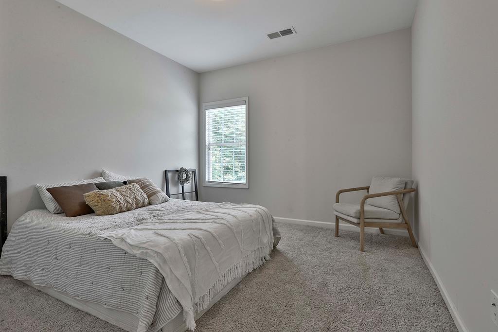 169 Hart Ridge Court Fortson, GA 31808 - Photo 26 of 50 a bedroom with a bed a chair and next to a window