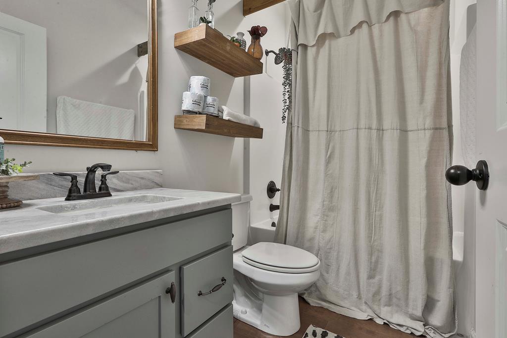 169 Hart Ridge Court Fortson, GA 31808 - Photo 27 of 50 a bathroom with a granite countertop sink vanity mirror and toilet