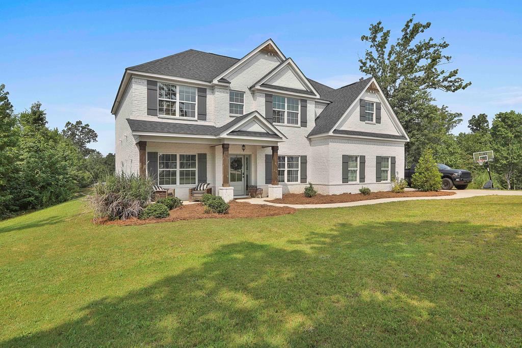 169 Hart Ridge Court Fortson, GA 31808 - Photo 3 of 50 a front view of a house with a yard table and chairs