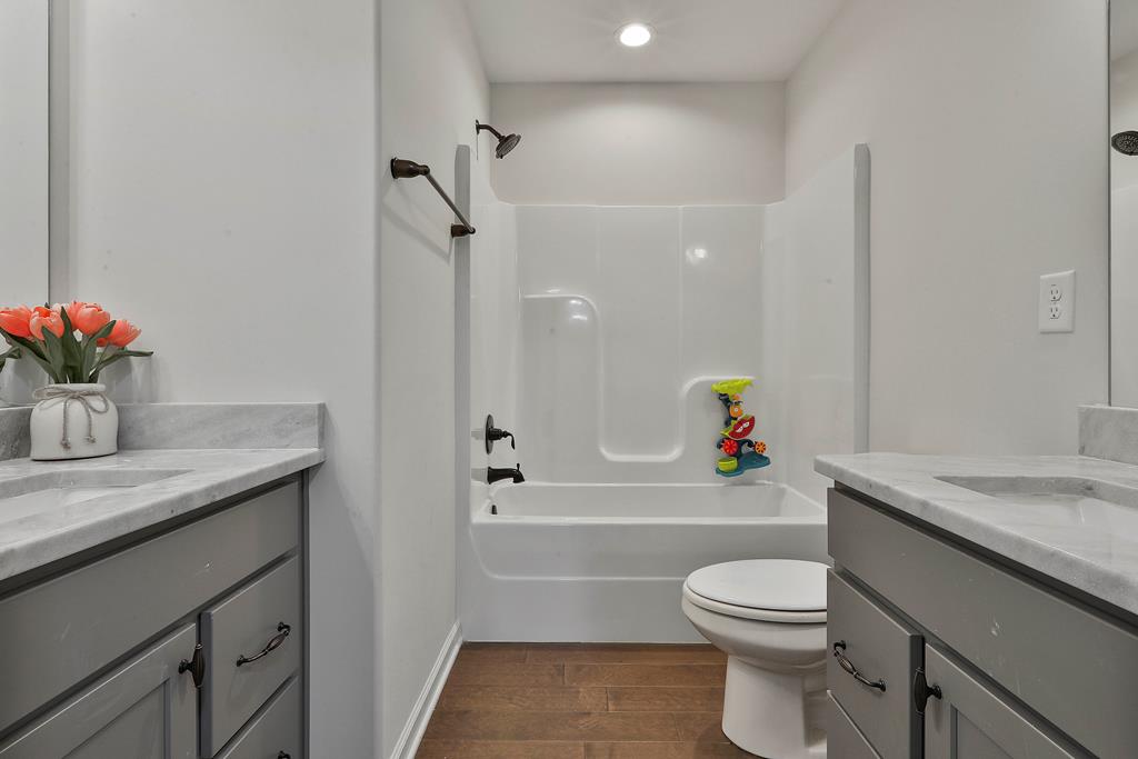 169 Hart Ridge Court Fortson, GA 31808 - Photo 37 of 50 a bathroom with a granite countertop sink a toilet and shower