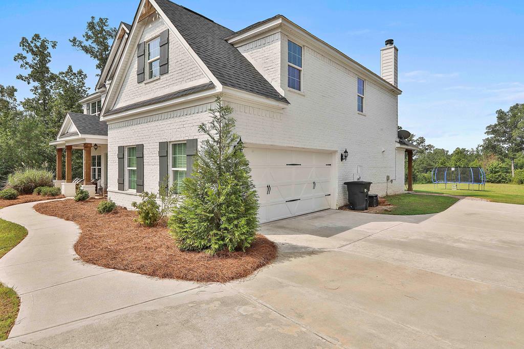 169 Hart Ridge Court Fortson, GA 31808 - Photo 4 of 50 a view of a white house with a yard and plants