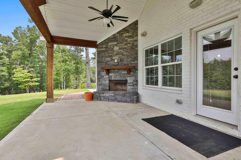 169 Hart Ridge Court Fortson, GA 31808 - Photo 44 of 50 a view of an empty room with wooden floor and a fireplace