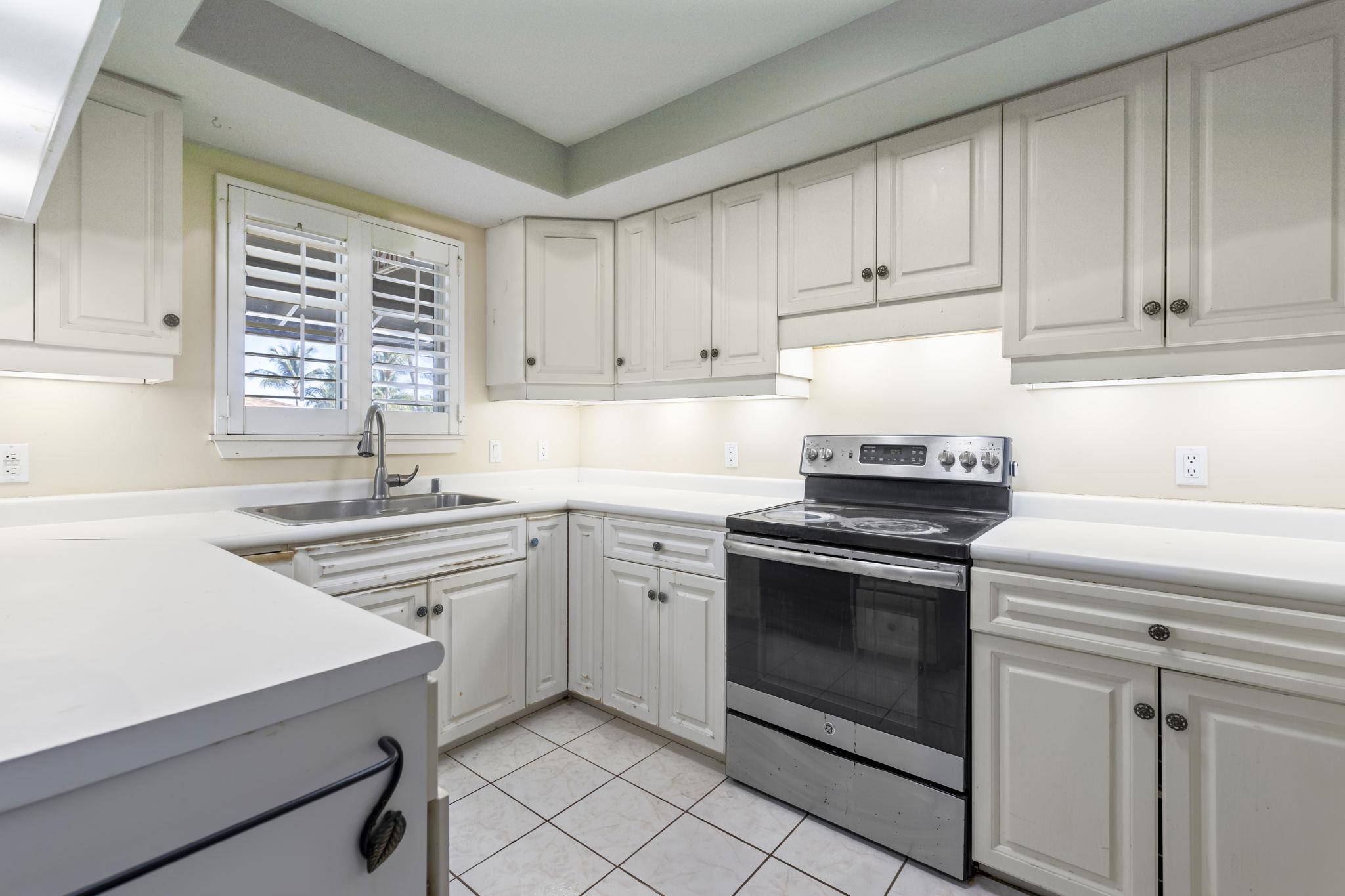 2058 Kanoe Street, Unit 2C Kihei, HI 96753 - Photo 5 of 27 a kitchen with cabinets appliances and a sink