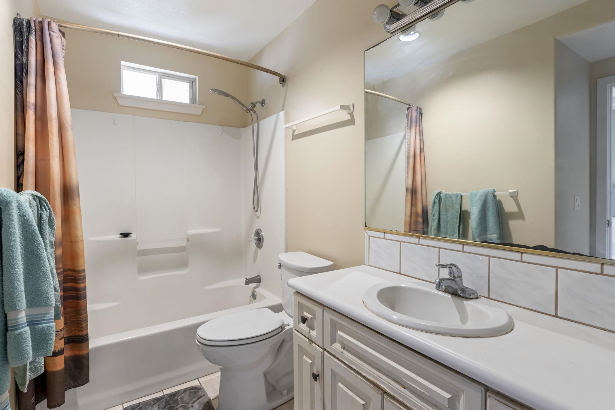 2058 Kanoe Street, Unit 2C Kihei, HI 96753 - Photo 7 of 27 a bathroom with a sink a toilet and a large mirror