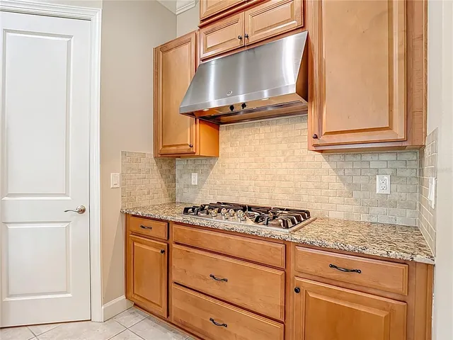 a kitchen with stainless steel appliances granite countertop a sink and a window