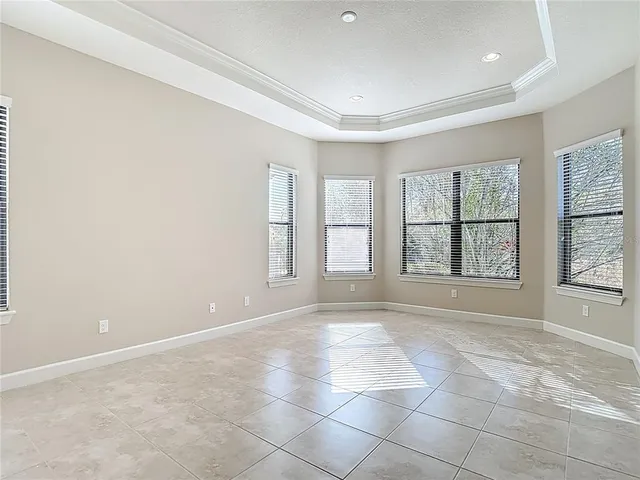 an empty room with windows and entrance