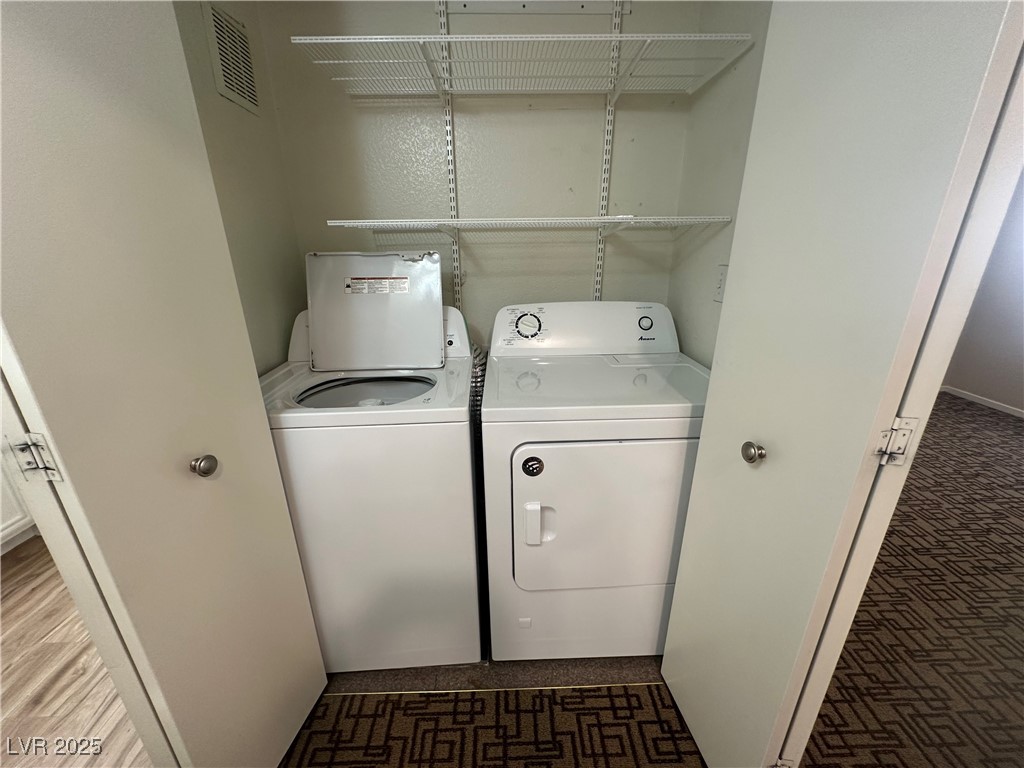 1908 High Valley Court, Unit 204 Las Vegas, NV 89128 - Photo 11 of 18 Laundry room with separate washer and dryer and baseboards