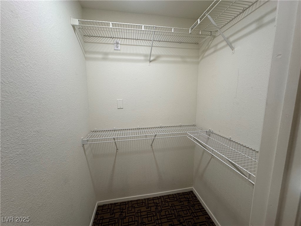 1908 High Valley Court, Unit 204 Las Vegas, NV 89128 - Photo 13 of 18 Walk in closet with dark carpet