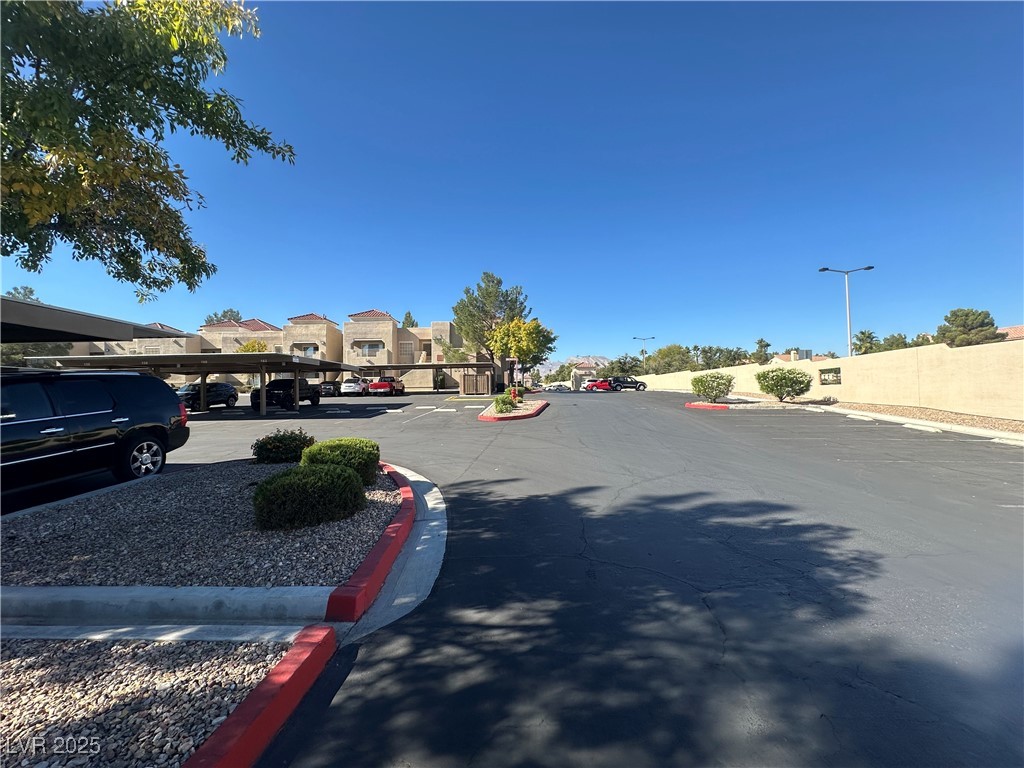 1908 High Valley Court, Unit 204 Las Vegas, NV 89128 - Photo 18 of 18 View of asphalt street with curbs, street lighting, and a residential view