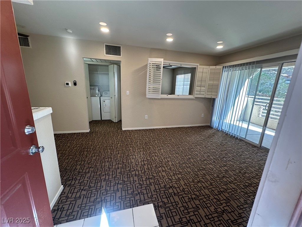 1908 High Valley Court, Unit 204 Las Vegas, NV 89128 - Photo 4 of 18 Empty room featuring recessed lighting, washer and clothes dryer, and dark carpet
