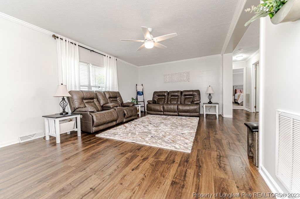 125 Wright Road Vass, NC 28394 - Photo 11 of 48 a living room with furniture and a wooden floor