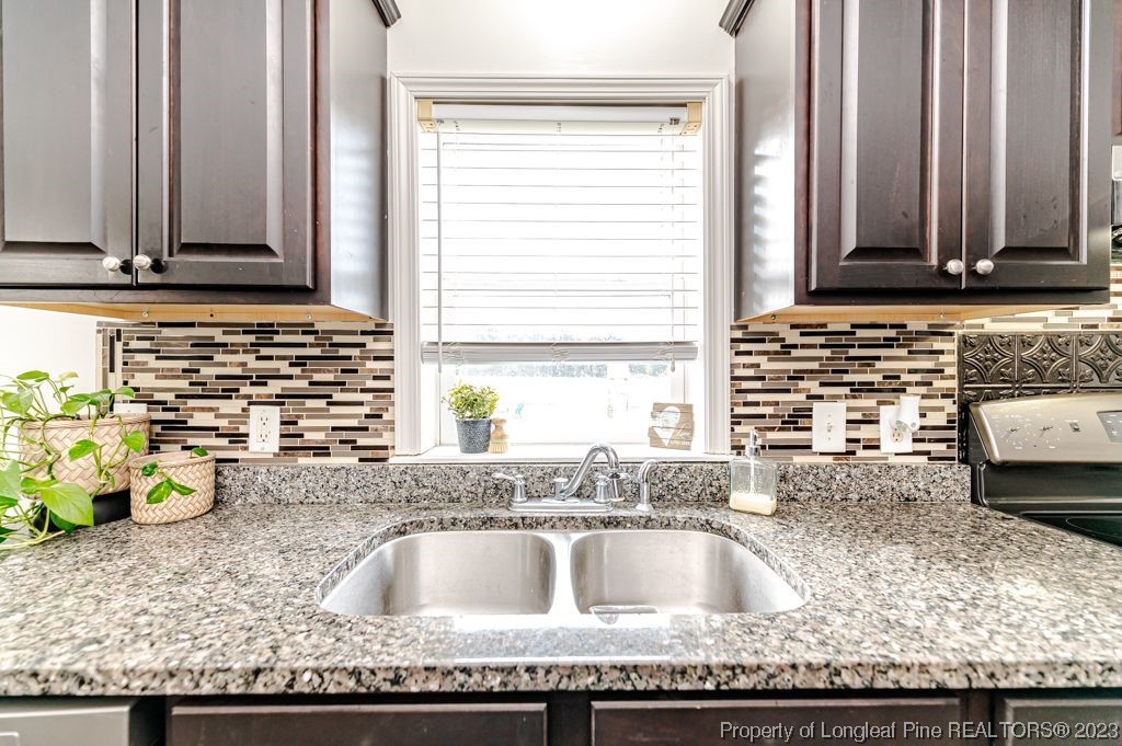 125 Wright Road Vass, NC 28394 - Photo 15 of 48 a kitchen with kitchen island granite countertop a sink and a counter top space