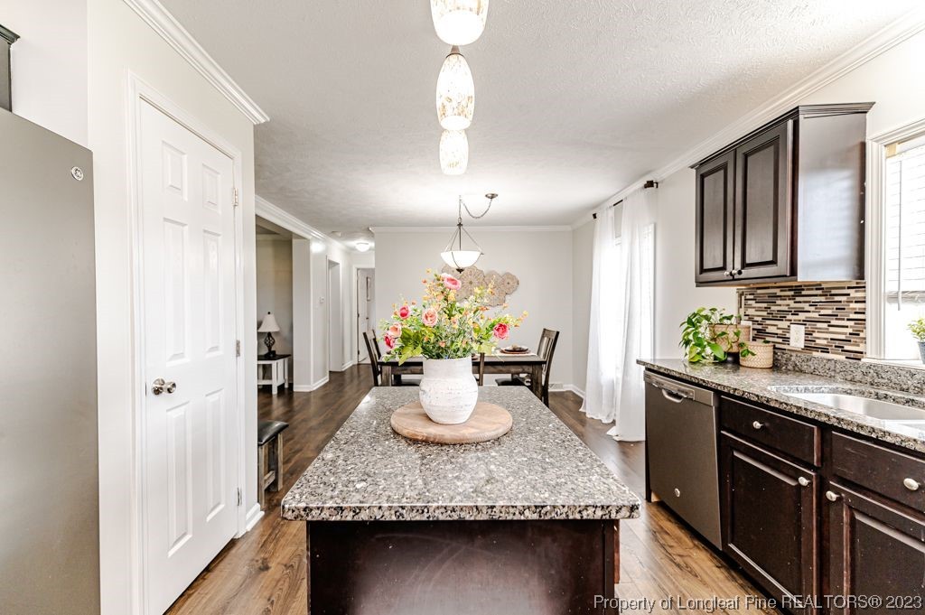 125 Wright Road Vass, NC 28394 - Photo 17 of 48 a kitchen with a granite counter space a sink stove and cabinets