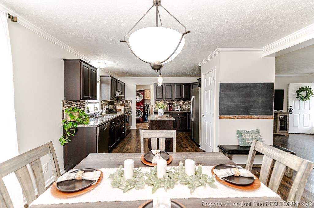 125 Wright Road Vass, NC 28394 - Photo 19 of 48 a view of a dining room with furniture a kitchen and chandelier