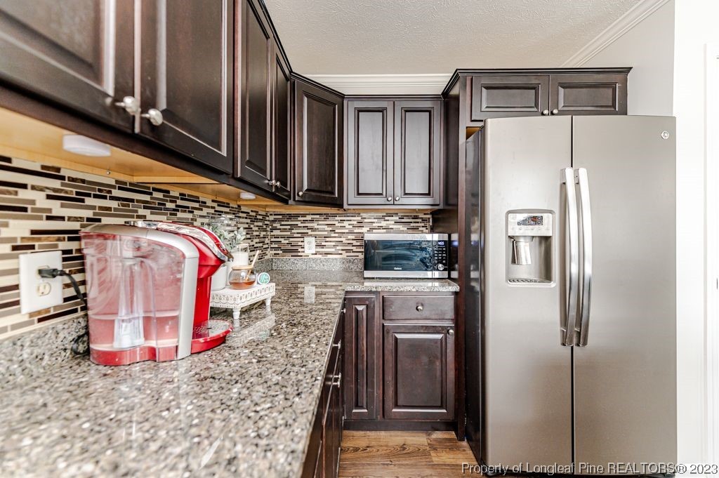 125 Wright Road Vass, NC 28394 - Photo 20 of 48 a kitchen with stainless steel appliances granite countertop a refrigerator and a stove