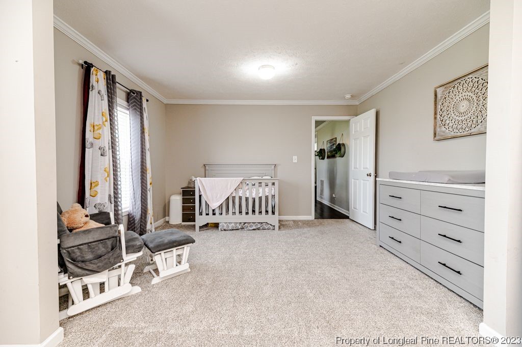 125 Wright Road Vass, NC 28394 - Photo 25 of 48 a view of a bedroom with bed and large window
