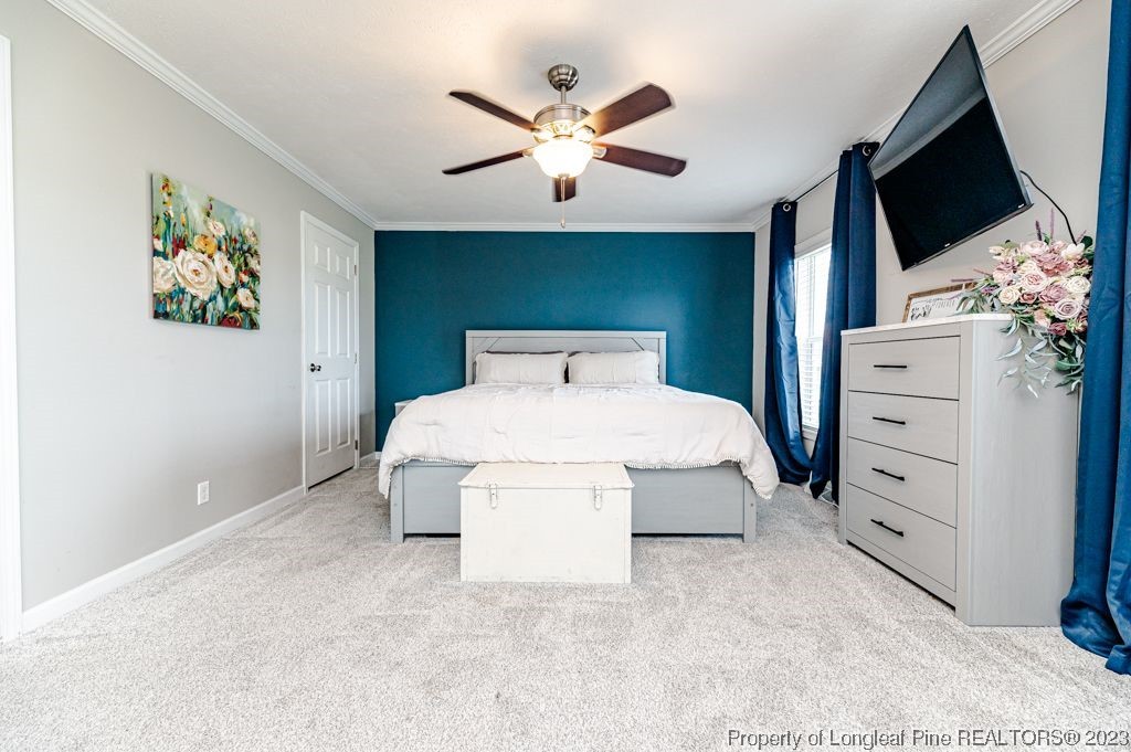 125 Wright Road Vass, NC 28394 - Photo 26 of 48 a bedroom with a bed and a flat screen tv