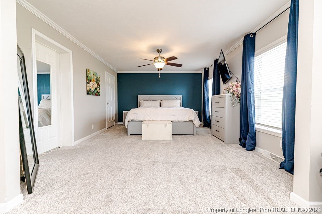 125 Wright Road Vass, NC 28394 - Photo 27 of 48 a living room with furniture and a chandelier