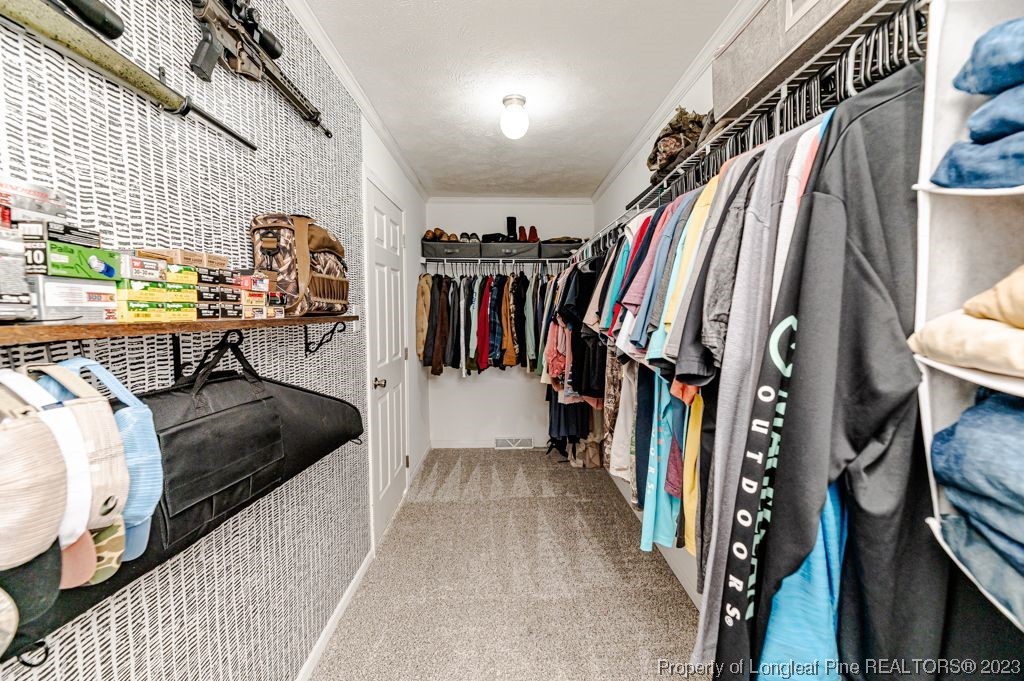 125 Wright Road Vass, NC 28394 - Photo 28 of 48 a view of walk in closet with clothes and shoes
