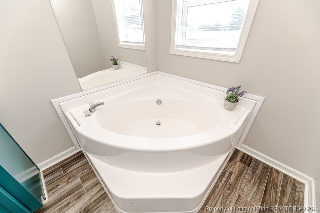 125 Wright Road Vass, NC 28394 - Photo 30 of 48 a bathroom with a bathtub and a window