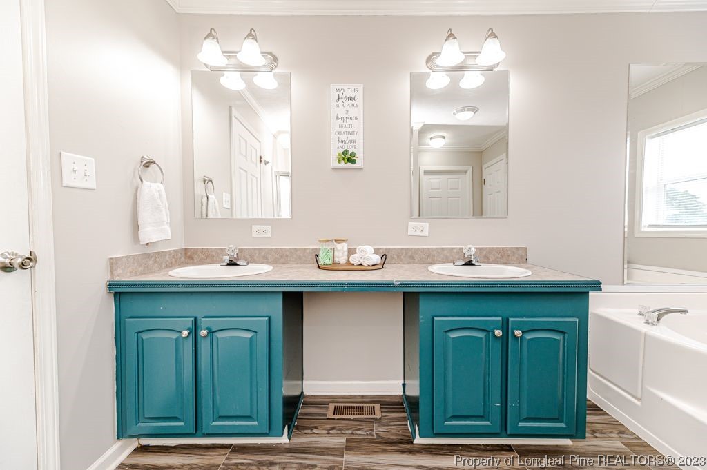125 Wright Road Vass, NC 28394 - Photo 32 of 48 a bathroom with a sink double vanity and a mirror