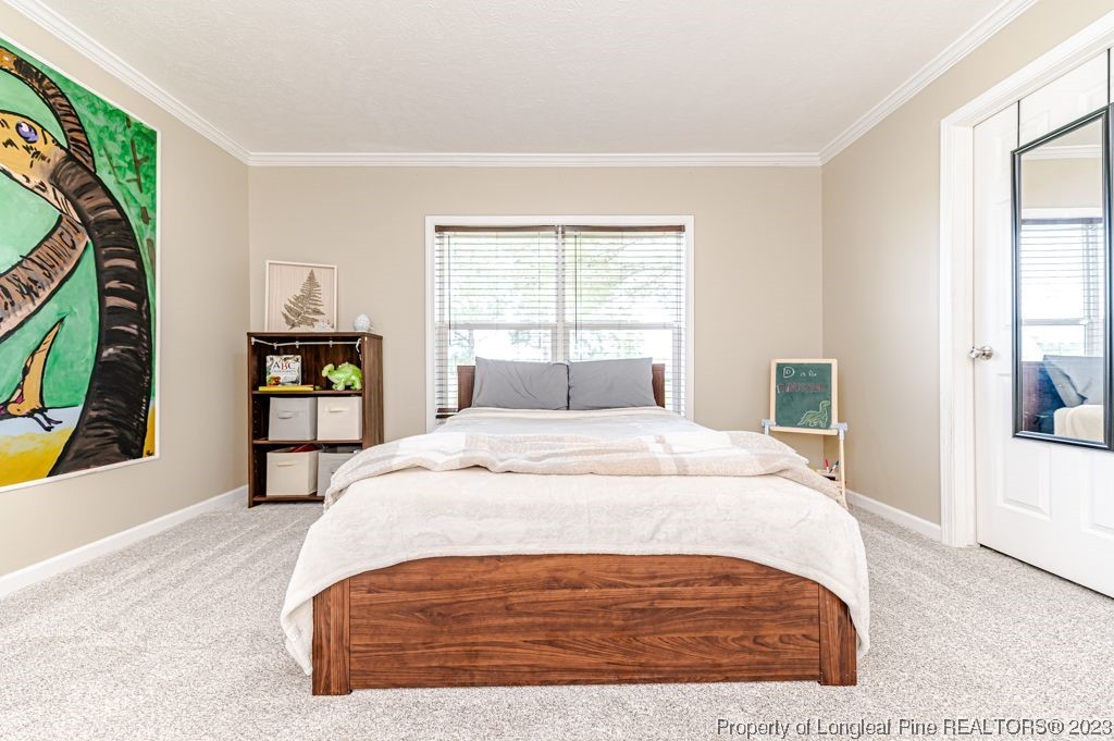 125 Wright Road Vass, NC 28394 - Photo 34 of 48 a bedroom with a bed and a large window