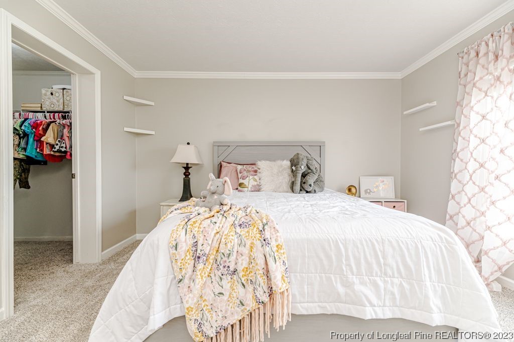 125 Wright Road Vass, NC 28394 - Photo 36 of 48 a bedroom with a bed and a window